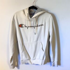 Champion Off-White Hoodie with Script Logo and Orange Emblem